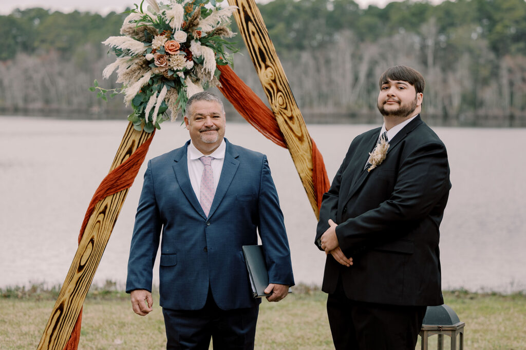 groom watching the bride walk down the aisle