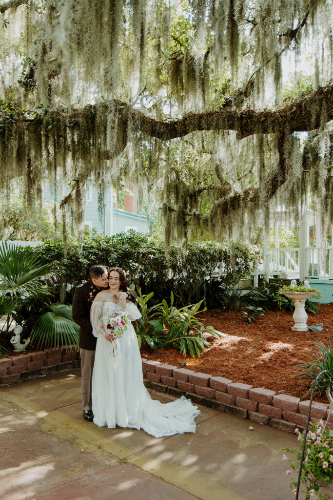 Groom, kissing the bride on the cheek