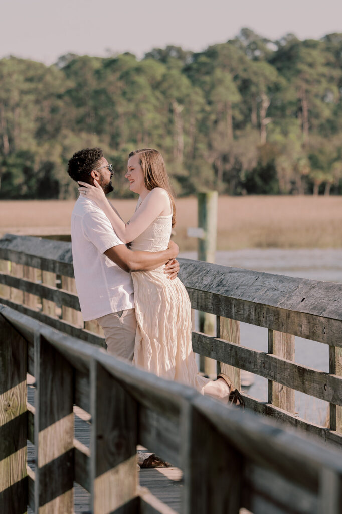 cute picture of the couple smiling at each other during their photoshoot