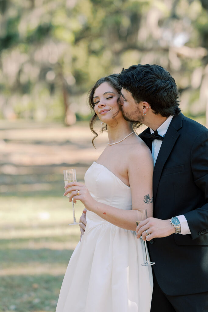 groom kissing the bride on the cheek