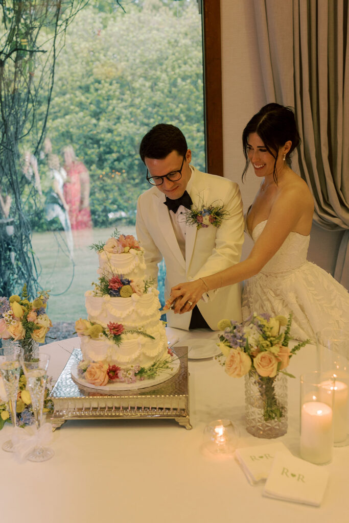 cute picture of the newlyweds cutting their wedding cake