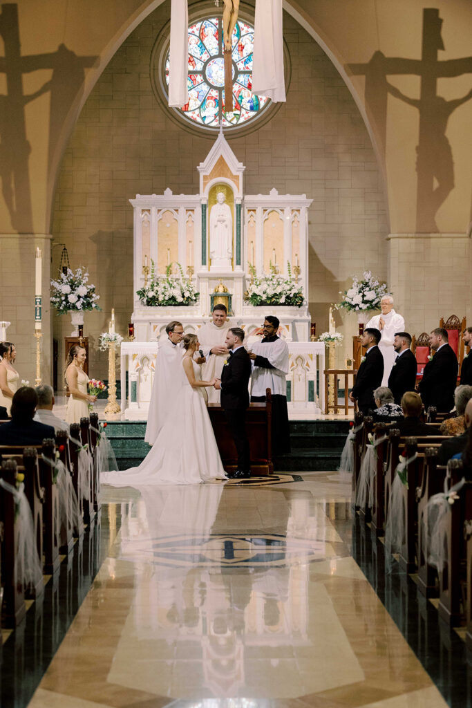 cute picture of the bride and groom holding hands during their ceremony