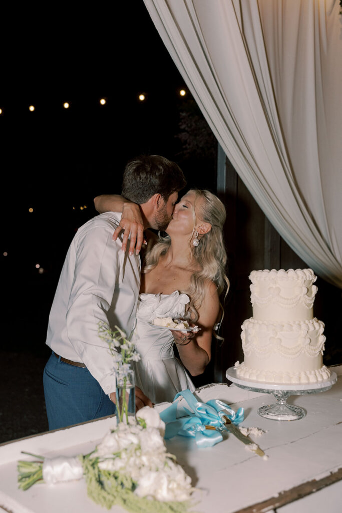 newlyweds kissing at their wedding reception