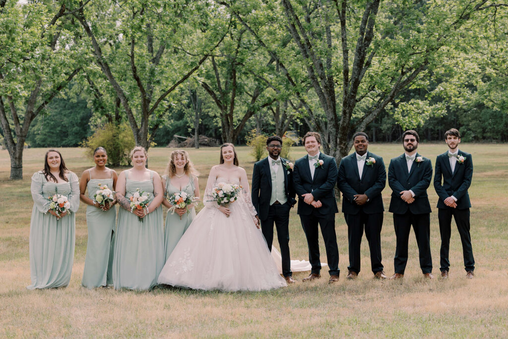 cute picture of the bride and groom with their bridal parties