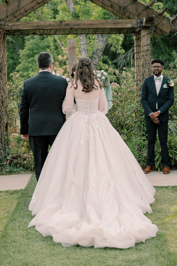 groom emotional watching the bride walk down the aisle