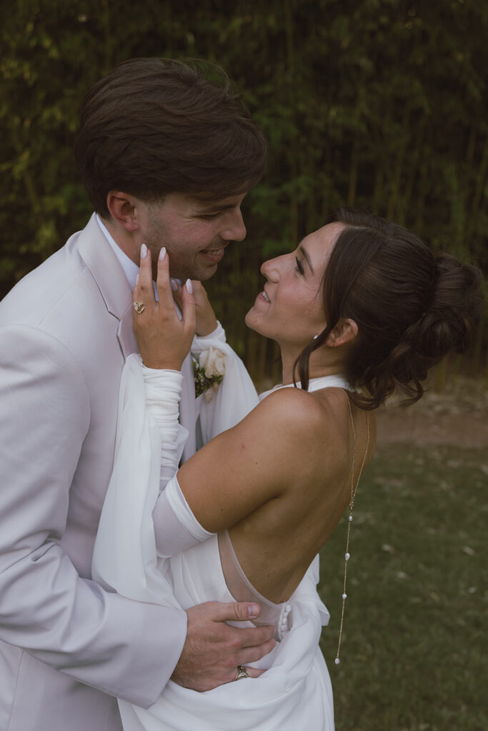 Newly married couple smiling at each other