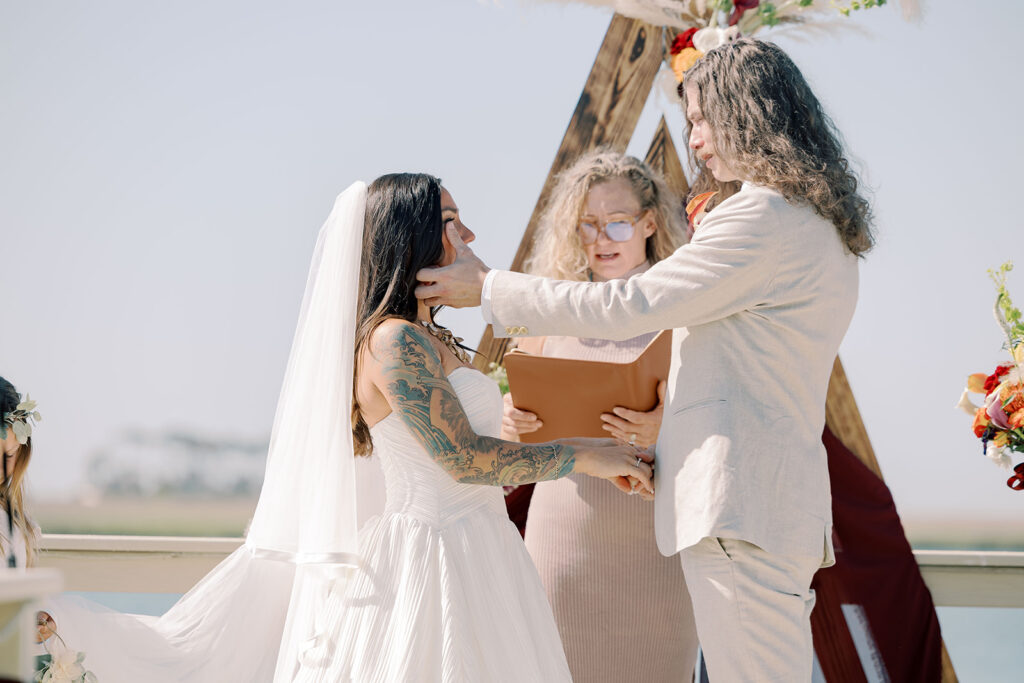 bride and groom holding hands during their ceremony