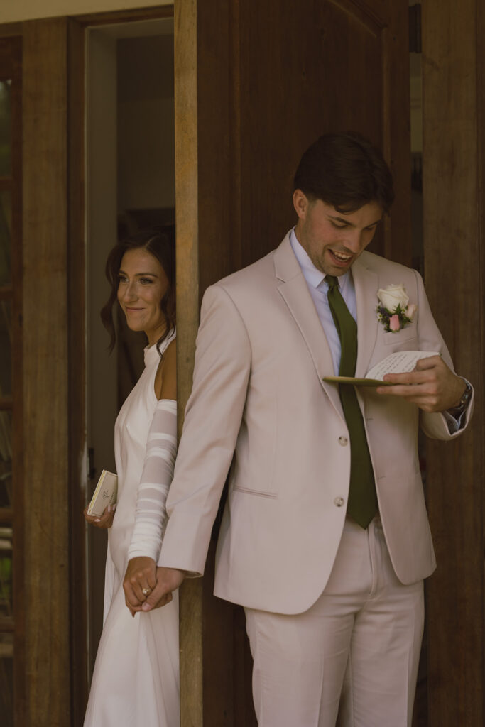 bride and groom reading her wedding vows