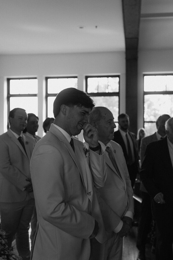 groom emotional watching the bride walk down the aisle