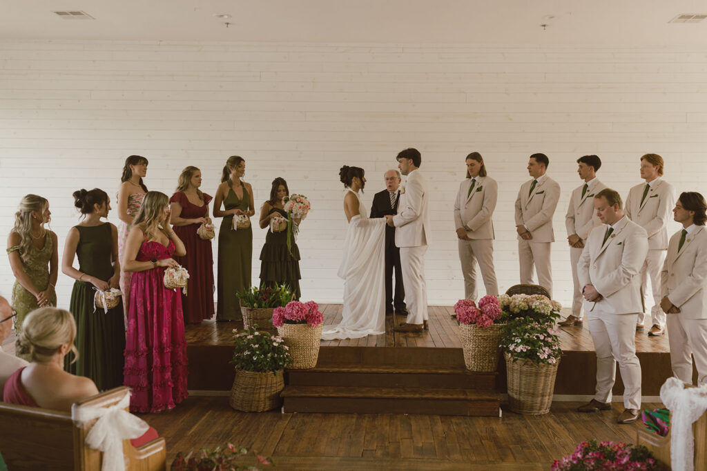 bride and groom holding hands during their wedding ceremony