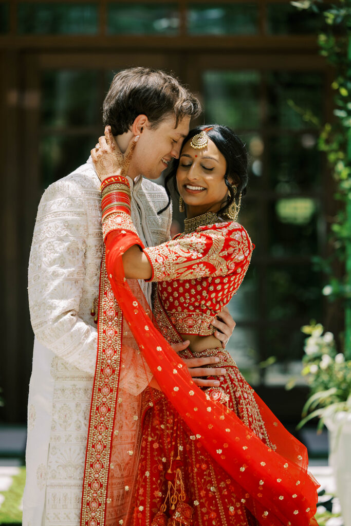 groom kissing the bride on the forehead during their ceremony