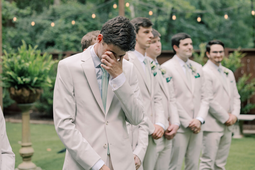groom emotional watching the bride walk down the aisle