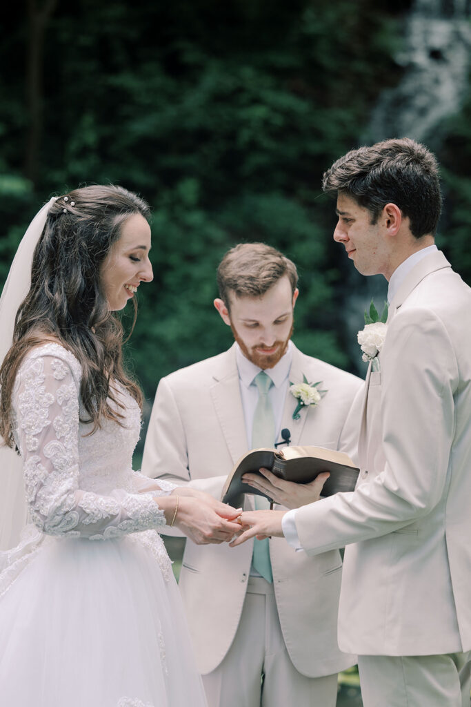 bride and groom holding hands during their wedding ceremony