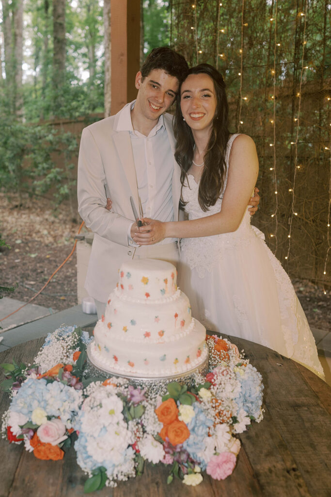 cute picture of the newlyweds cutting their wedding cake