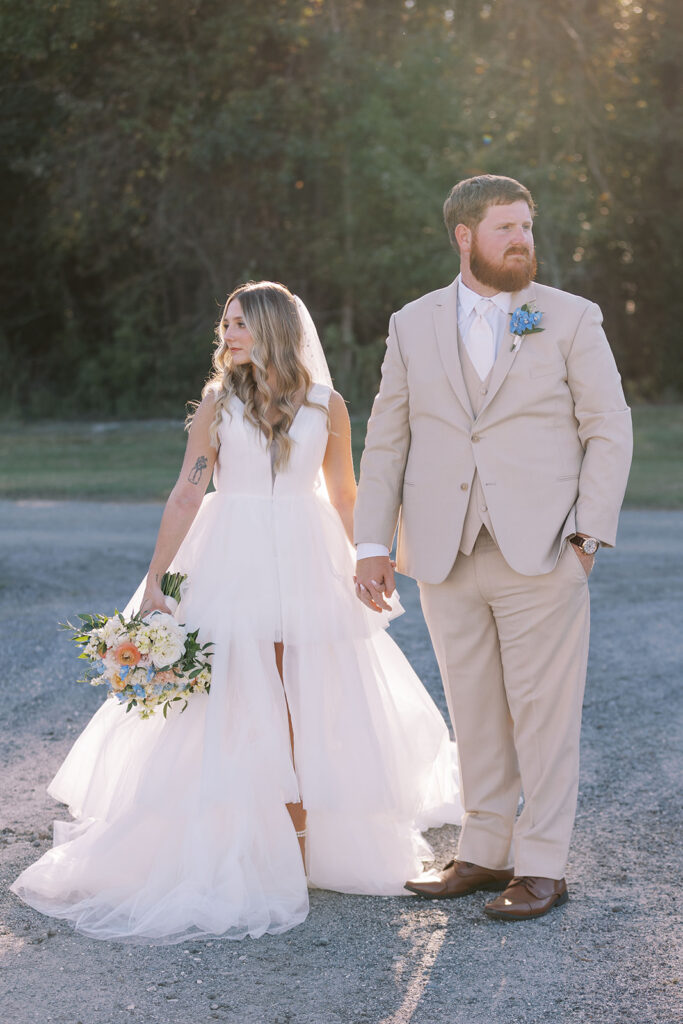 portrait of the bride and groom holding hands