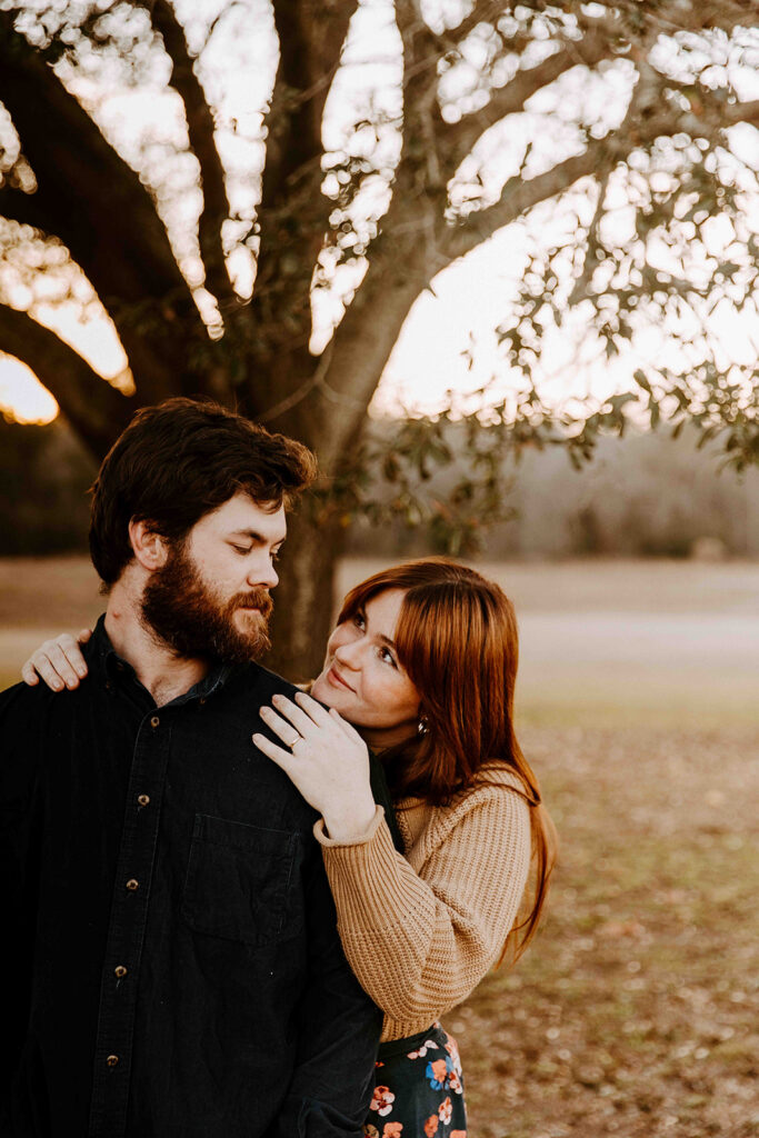 couple smiling at each other during their photoshoot