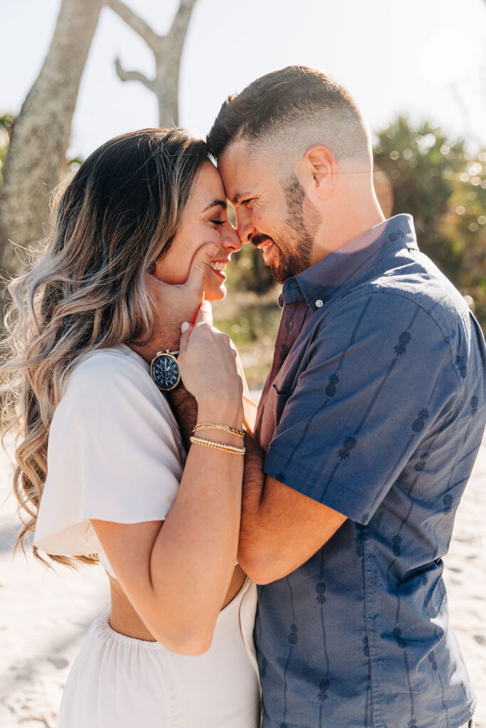 couple smiling at each other during their session