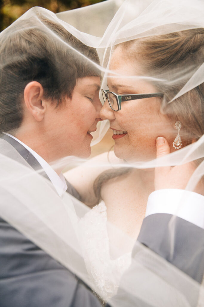 bride and groom smiling at each other during their session