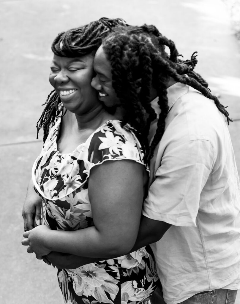Couple laughing with each other during their session