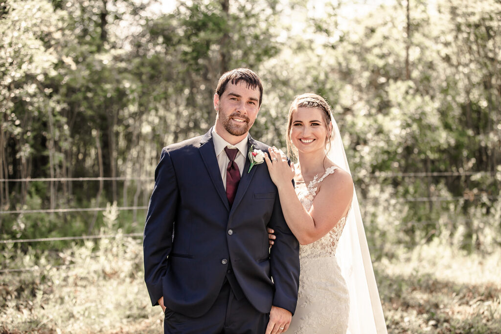 Bride and groom, smiling at the camera during their bridal session