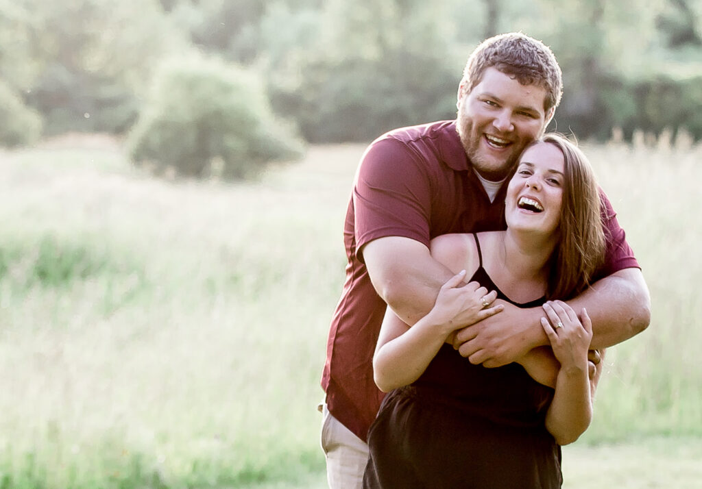 Couple laughing with each other during their session