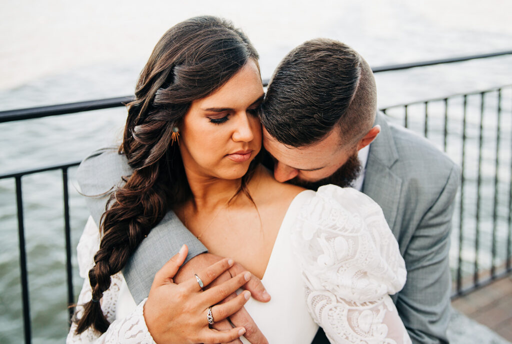 groom kissing the bride on the cheek