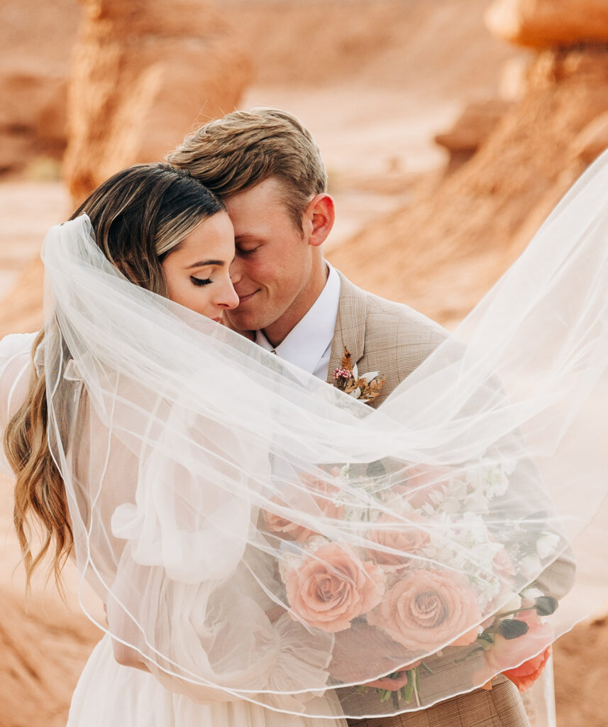groom kissing the bride on the forehead