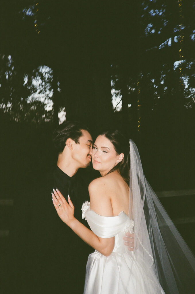 groom kissing the bride on the cheek