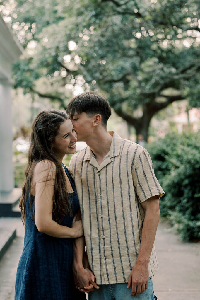 fiance kissing his fiance on the forehead