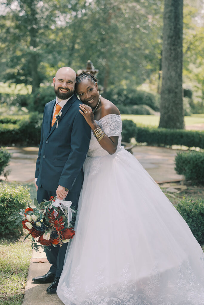 Bride and groom, smiling at the camera during their bridal portraits
