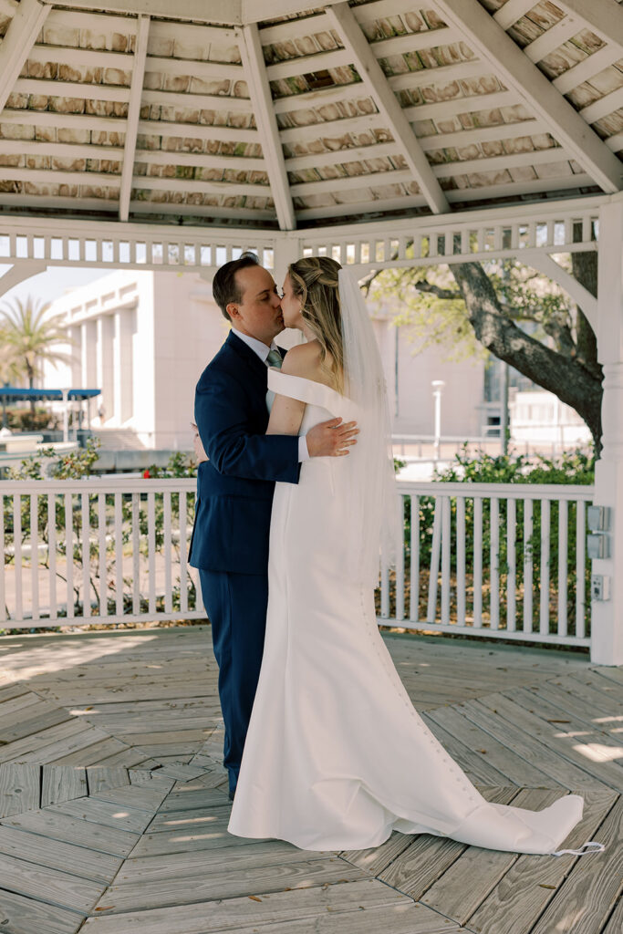 cute picture of the bride and groom kissing after their first look